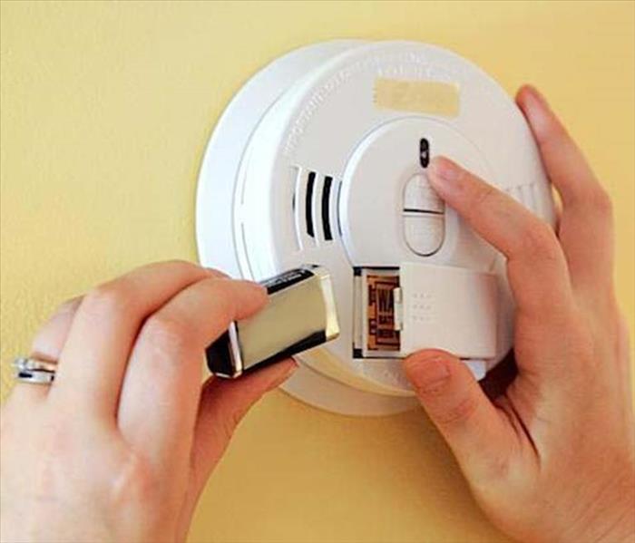 Battery being changed in a smoke alarm